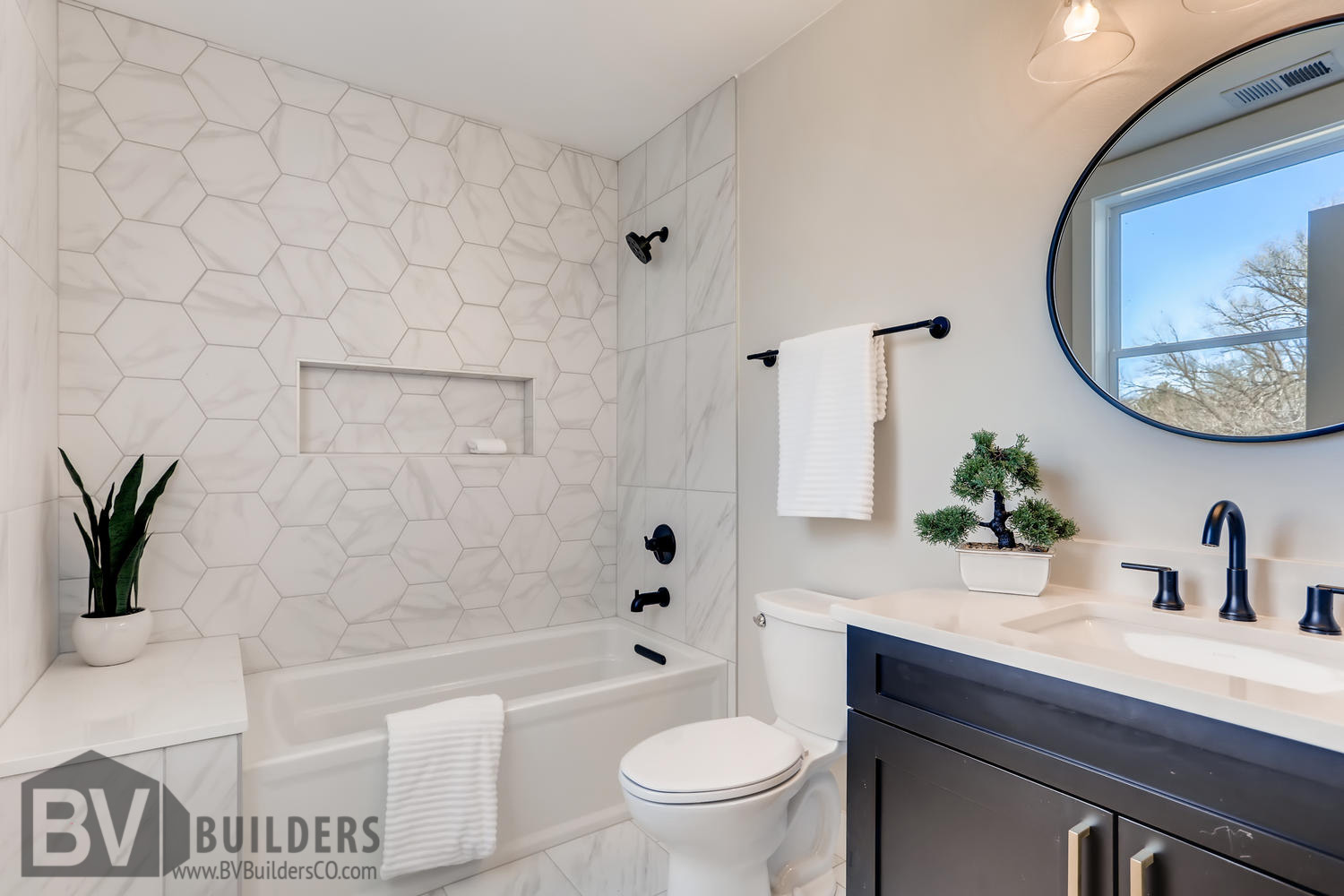 Bathroom with marble hexagon shower surround and recessed niche