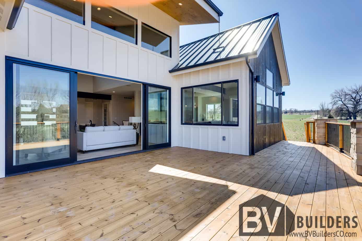 Modern farmhouse with Thermory wood deck and large sliding glass door