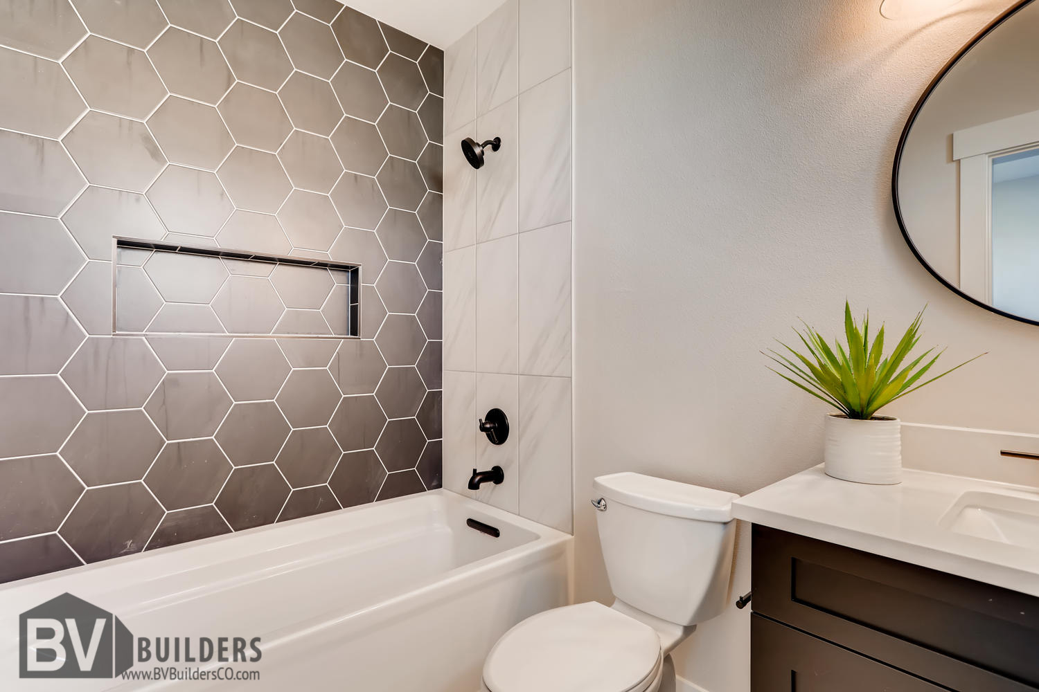 Shower with black hegagon tile and recessed niche