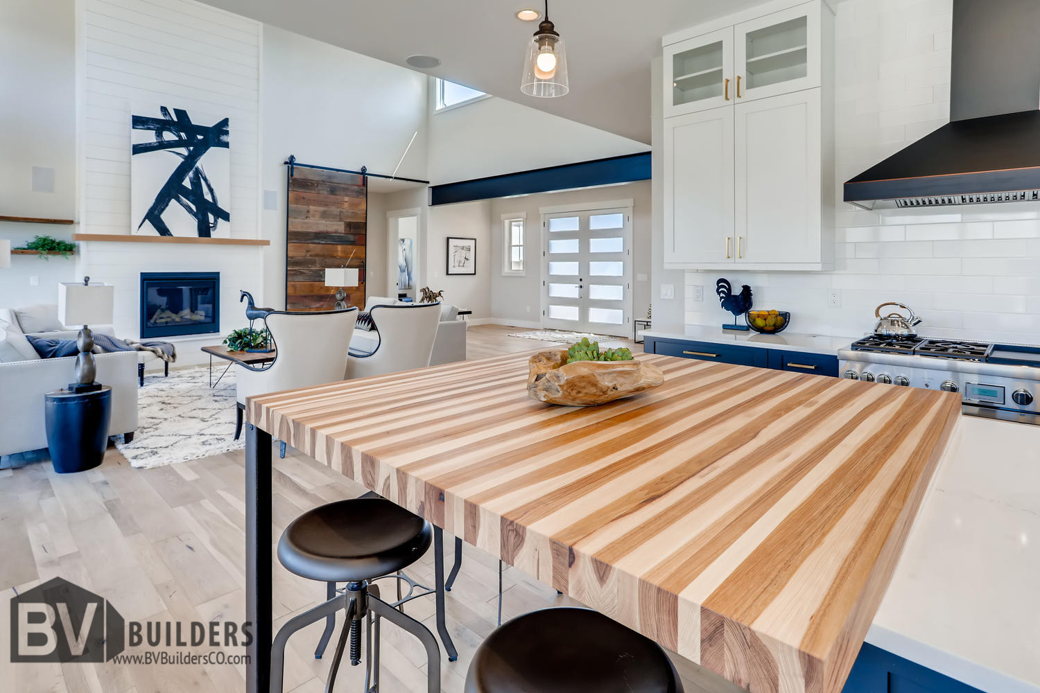 Kitchen island with butcher block bar, barn door, exposed steel beam