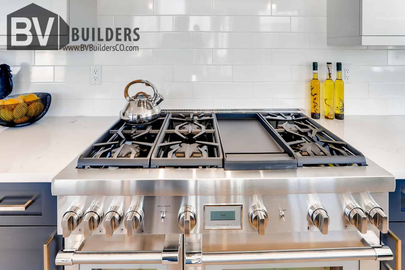 Thermador gas range with white subway tile backsplash