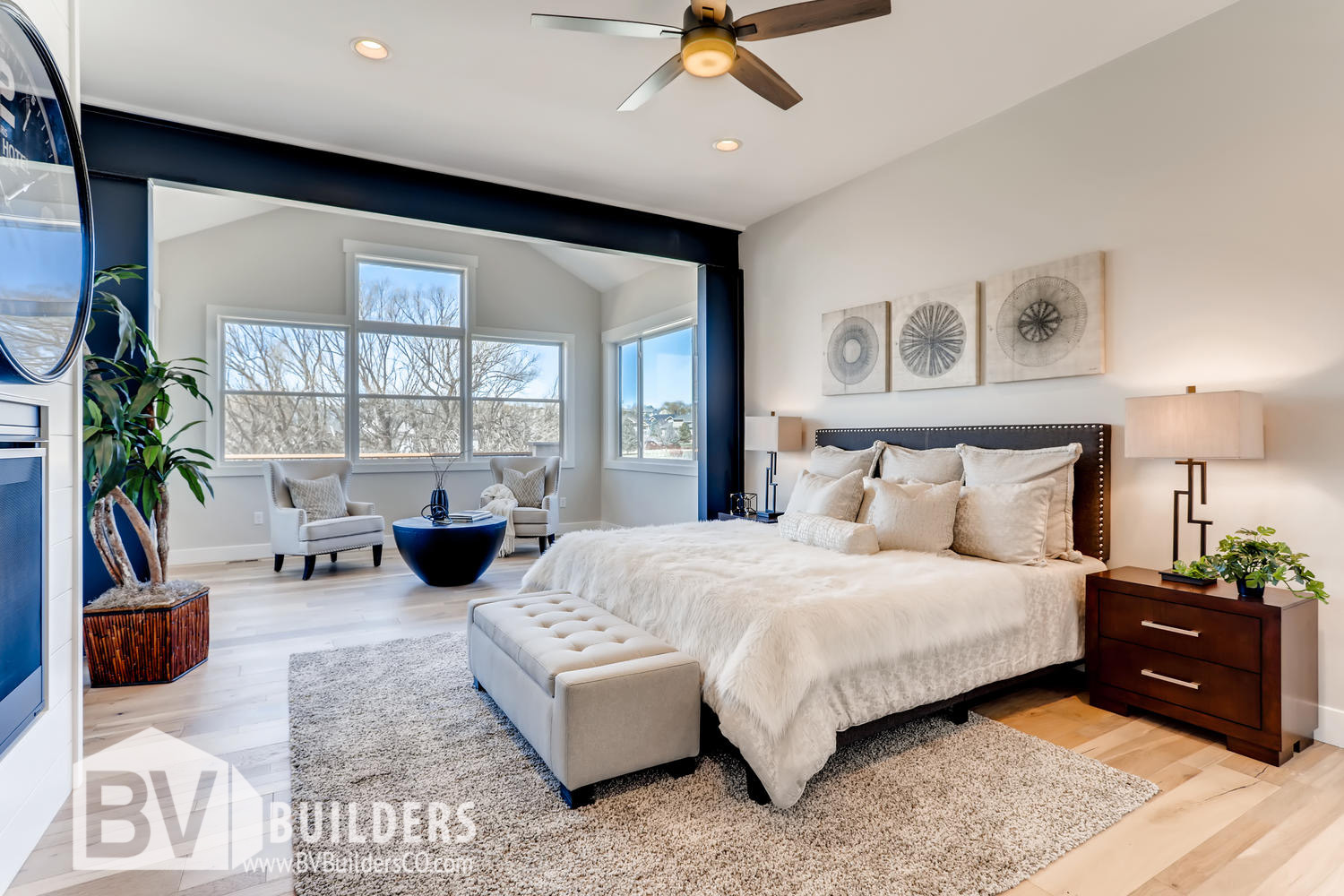 Modern farmhouse master bedroom with exposed steel beams and shiplap fireplace