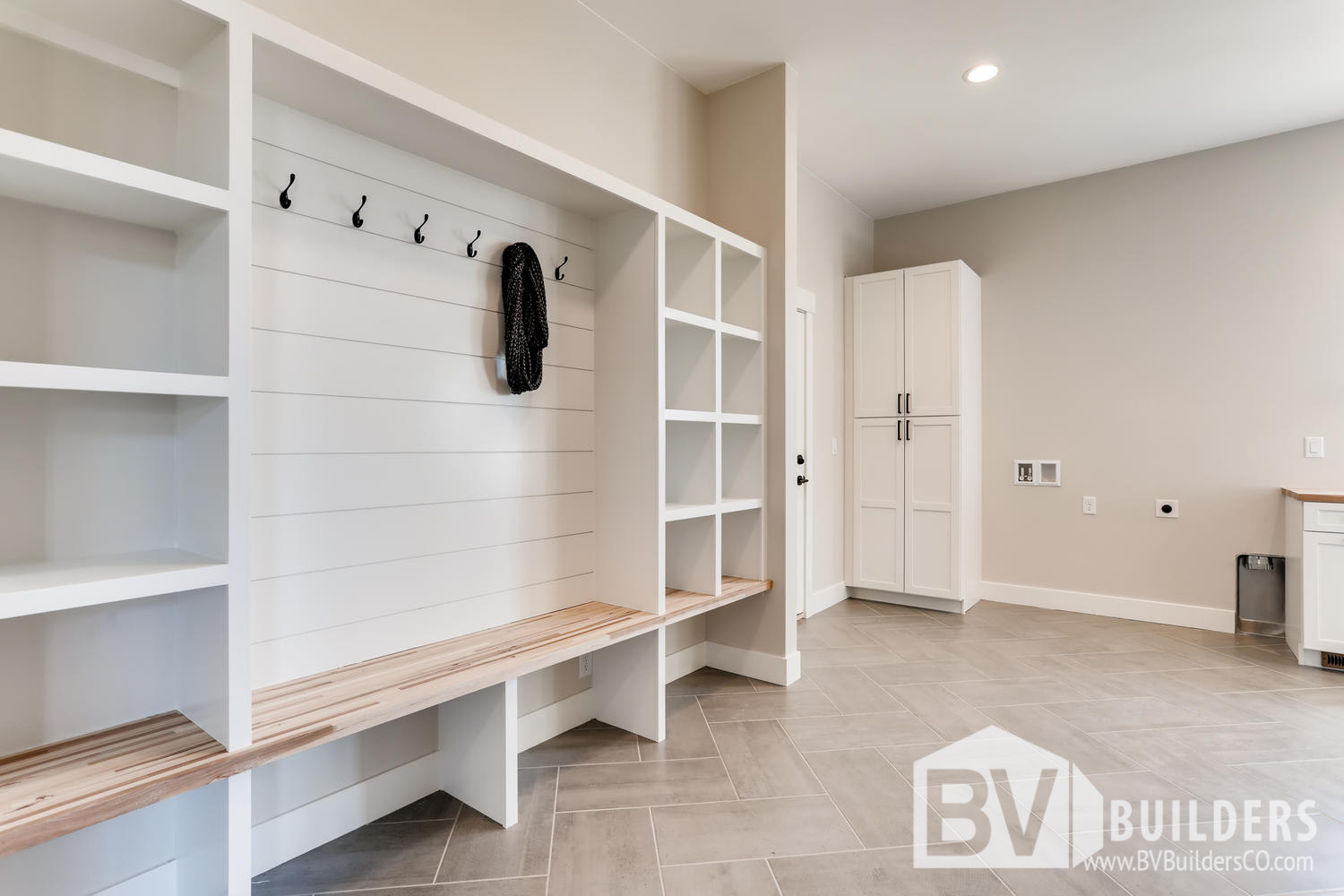 Mud room with built in bench, cubbies and shiplap coat hook wall