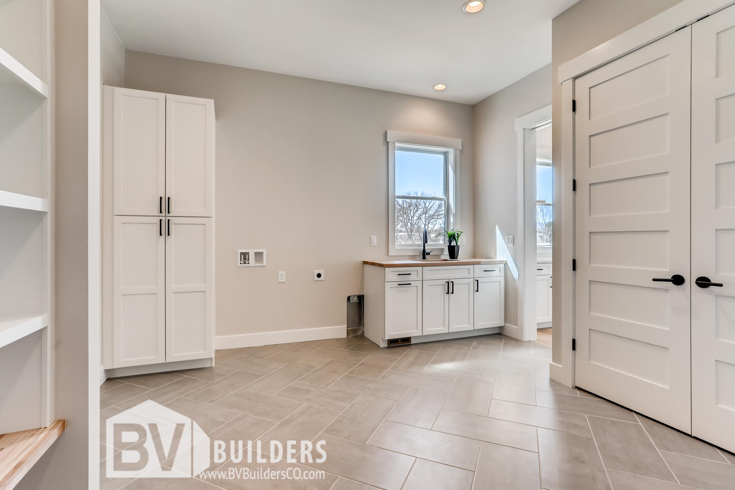 Modern farmhouse mudroom with herringbone tile floor