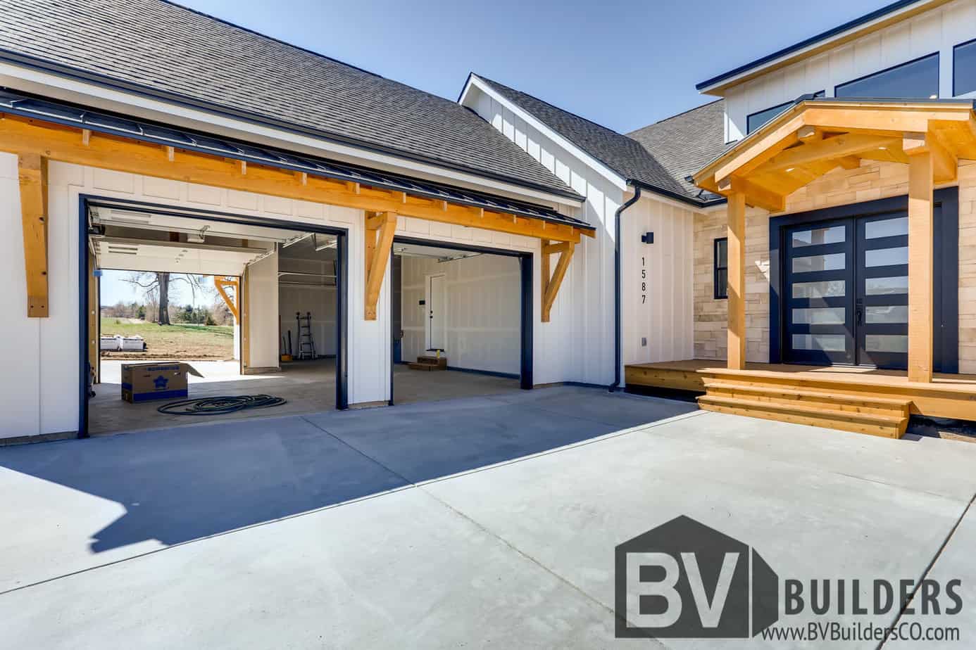 Modern farmhouse with a pull through garage and timber framing